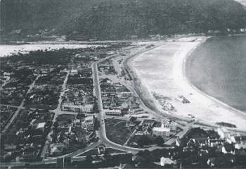 A view up Main Road Fish Hoek showing Devonshire Court in the 1940s and the row of buildings behind which became The Arcade in 1986. A view up Main Road Fish Hoek showing Devonshire Court in the 1940s and the row of buildings behind which became The Arcade in 1986.